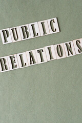 sign with the words "public relations" on green paper