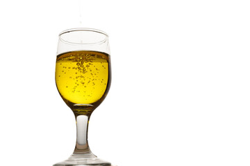 glass cup with extra virgin olive oil with bubbles