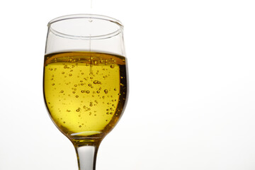 glass cup with extra virgin olive oil with bubbles