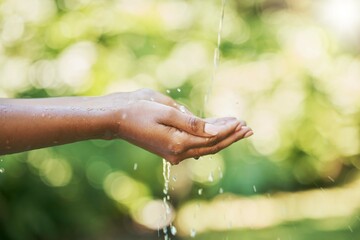 Hands, water and sustainability or cleaning for hydration, wash or hygiene in care, splash and wellness in nature. Hand of person washing in clean natural aqua liquid to prevent germs or remove dirt