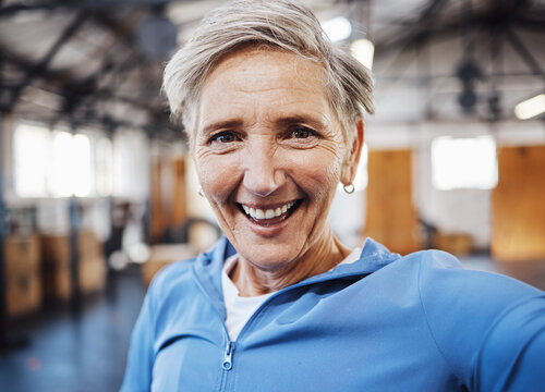 Selfie, smile and fitness senior woman taking picture in the gym after exercise, workout or training having fun. Elderly, old and portrait of fit female happy for wellness and health on social media