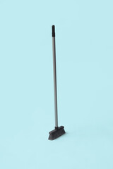 Plastic sweeping broom on color background