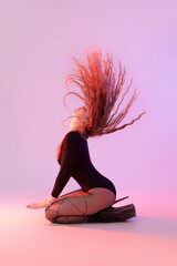 Attractive female dancer in high heels on color background