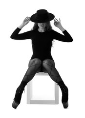 Attractive female dancer in high heels on white background