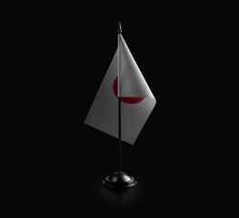Small national flag of the Japan on a black background