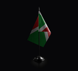 Small national flag of the Burundi on a black background