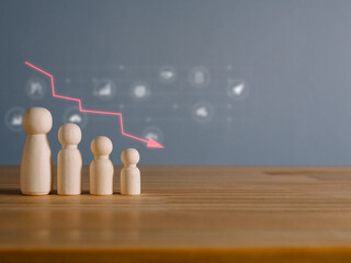 Man made of wood with a falling graph. Global financial crisis. The performance of the team is...