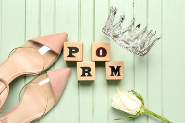 Word PROM, tiara, rose and heels on green wooden background © Pixel-Shot