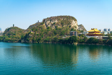Fototapeta na wymiar Temples and pagodas on riverside mountains, Liuzhou, Guangxi, China