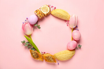 Frame made of flowers, eggs and treats on pink background. Novruz Bayram celebration