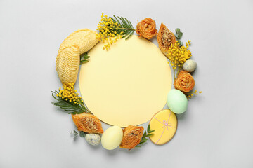 Blank card with flowers, eggs and treats on grey background. Novruz Bayram celebration