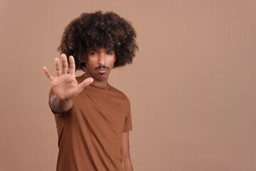 Fototapeta na wymiar African man gesturing prohibition with hand