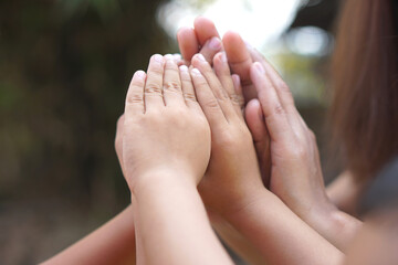 The hands of a child and a mother join forces.