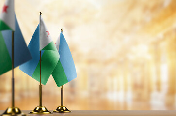 Small flags of the Djibouti on an abstract blurry background