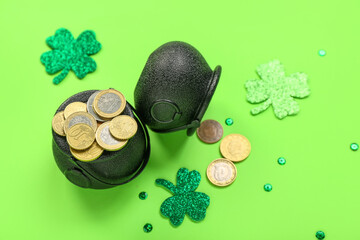 Pots with coins, paper clovers and sequins on green background. St. Patrick's Day celebration