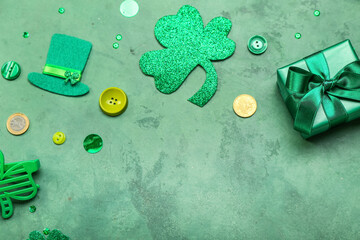 Gift with paper decor and buttons on green background. St. Patrick's Day celebration