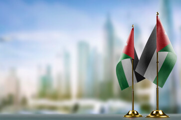 Small flags of the Jordan on an abstract blurry background