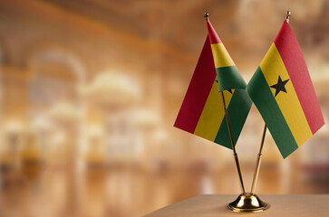 Small flags of the Ghana on an abstract blurry background