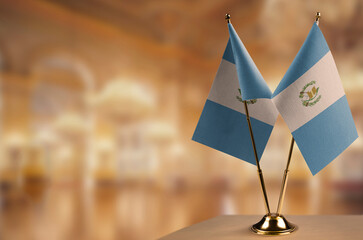 Small flags of the Guatemala on an abstract blurry background
