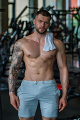 Fototapeta na wymiar Handsome man preparing for workout. Sport. Weight workout. Guy doing bodybuilding workout in gym. Sport, bodybuilding and fitness. Man exercising with dumbbell. Hard workout.