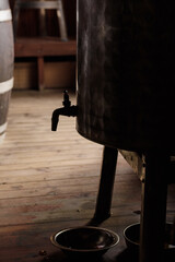 An old olive oil barrel with a tap. Selective focus