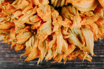 squash blossom or Zucchini flowers on a old wooden table Mexican food in Mexico Latin America