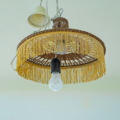 an old chandelier with light bulbs is temporarily hanging for the repair period of plastering the...