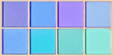 Vivid colored eye shadow makeup palette as banner violet, blue, teal colors. Female cosmetic and beauty product, trendy color of eyeshadow in square package, aesthetic texture background