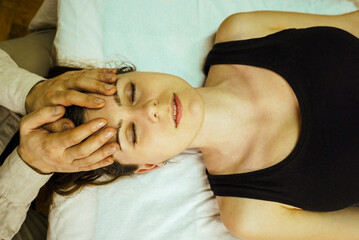 a CST treatment session for a woman, Osteopathic Manipulation and CranioSacral Therapy,  head...