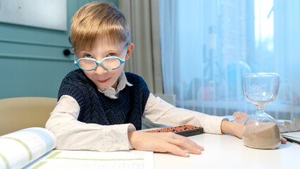 the boy solves examples on the abacus
