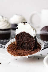 chocolate cake with chocolate muffin cupcake with butter cream and syrup and whipped cream