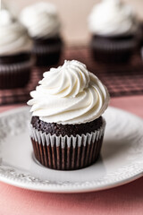 chocolate cake with chocolate muffin cupcake with butter cream and syrup and whipped cream