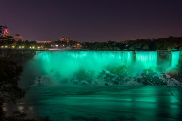 Niagara Falls lit up in green. Ontario, Canada.