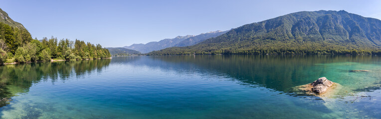 Fototapeta na wymiar Summer at Lake Bohinj in the Julian Alps - panorama of the lake surrounded by mountains