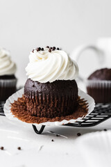 chocolate cake with chocolate muffin cupcake with butter cream and syrup and whipped cream