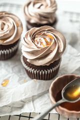 chocolate cake with chocolate muffin cupcake with butter cream and syrup and whipped cream