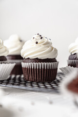 chocolate cake with chocolate muffin cupcake with butter cream and syrup and whipped cream