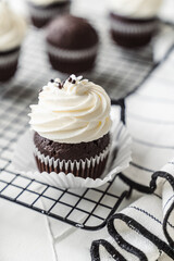 chocolate cake with chocolate muffin cupcake with butter cream and syrup and whipped cream
