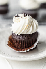 chocolate cake with chocolate muffin cupcake with butter cream and syrup and whipped cream