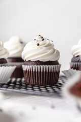 chocolate cake with chocolate muffin cupcake with butter cream and syrup and whipped cream
