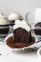 chocolate cake with chocolate muffin cupcake with butter cream and syrup and whipped cream