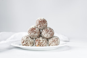 Coconut and chocolate truffles, homemade chocolate bonbons on white background, desiccated coconut coated truffles