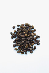 Coffee beans spread on the white background  closeup