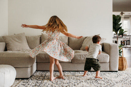 Siblings Twirling in Living Room