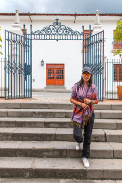 Woman walking down steps in the white city of Popayan, Colombia