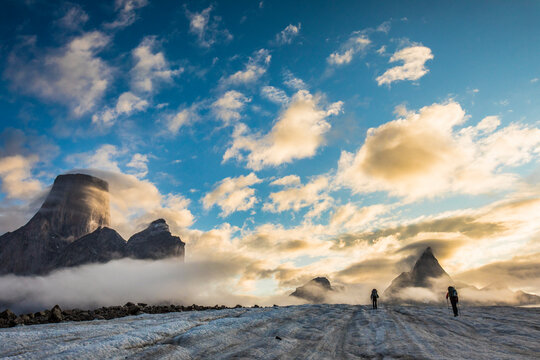 Climbers set up tent on glacier below Mt. Loki, Baffin Island.
