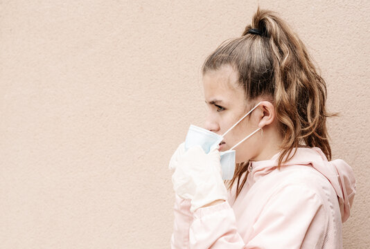 one blonde girl wearing latex gloves and face masks is showing the way she protects herself from coronavirus, bacterias, virus, fungus, etc. She removed mask to take clear breath. 