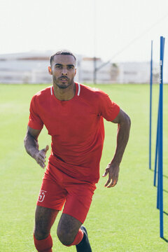 Upper part of male African American soccer player practicing at pitch