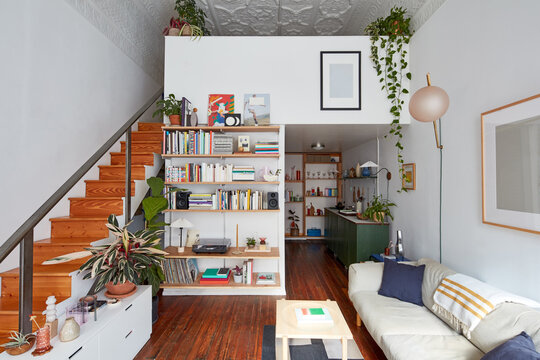 Interior of loft apartment livingroom, stairs, and kitchen