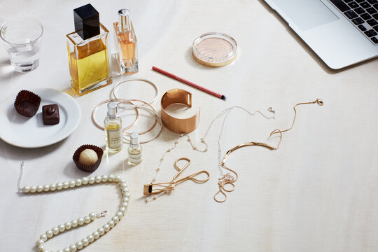 Still life with fashion accessories, computer, perfume